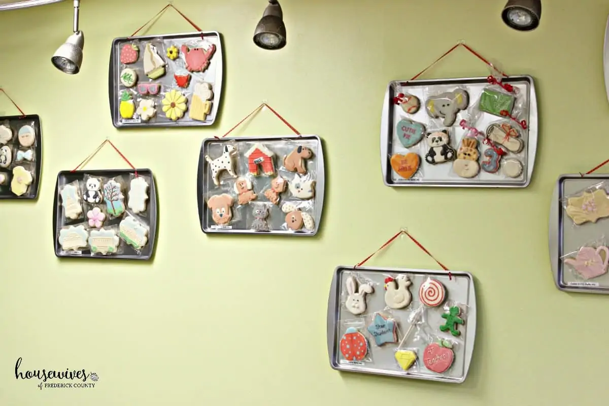Samples of different cookie decorating themes are on the walls