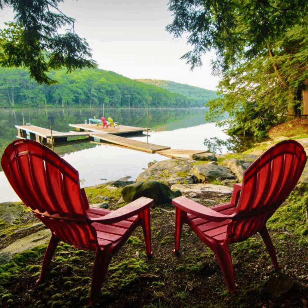 Serene setting at Deep Creek Lake, Maryland with adirondack chairs and the lake in the distance