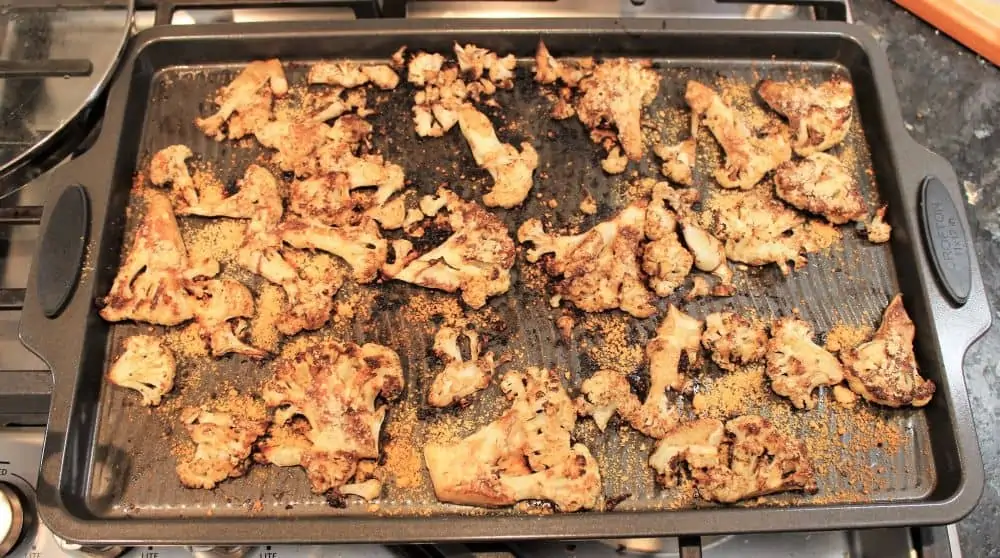 Remove cauliflower steaks from the oven