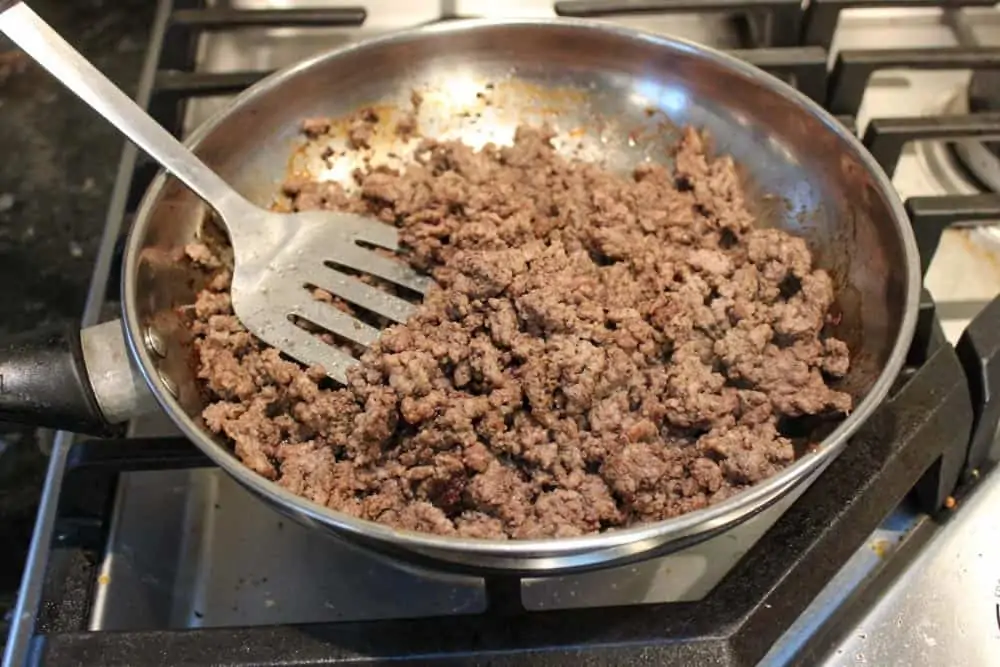 Brown lean ground beef in frying pan until cooked through