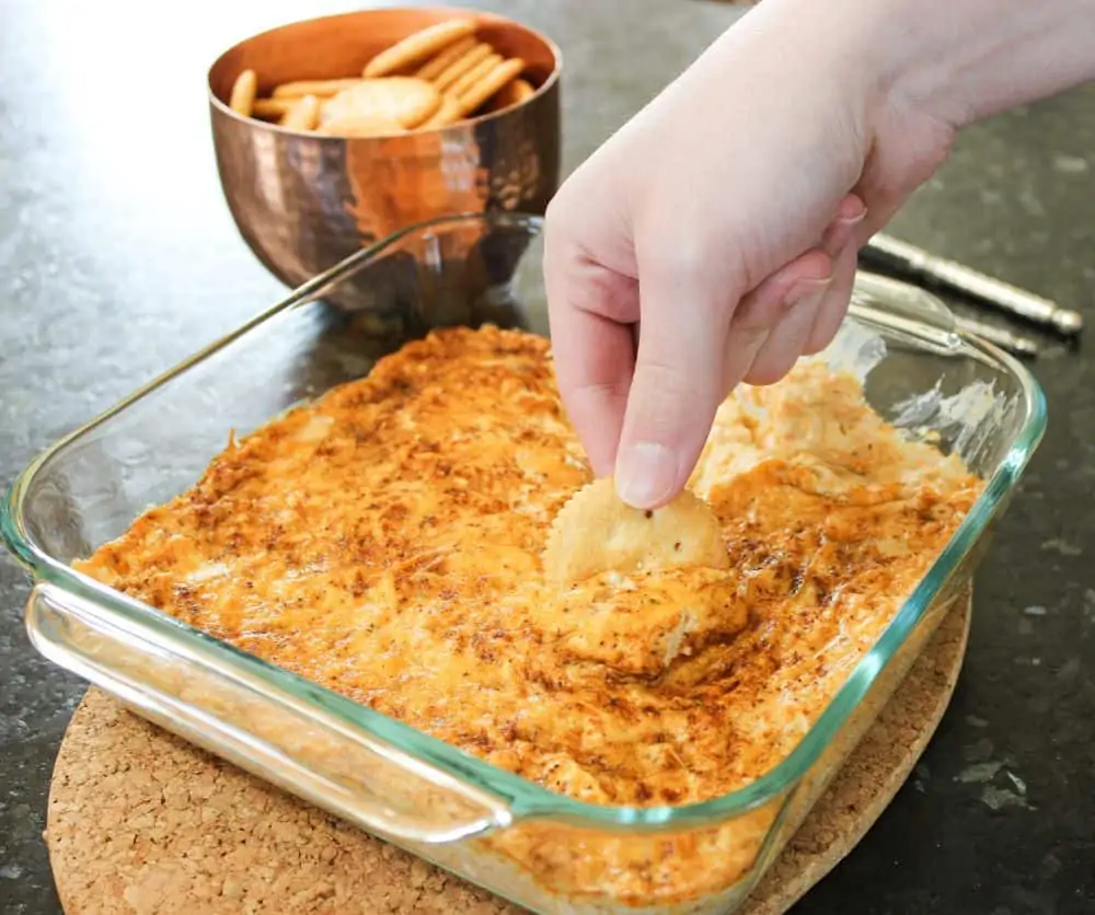 Son dipping into the hot crab dip