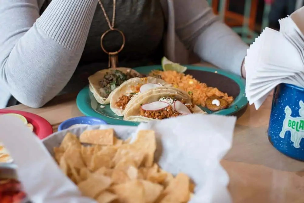 People enjoying Mexican tacos. 