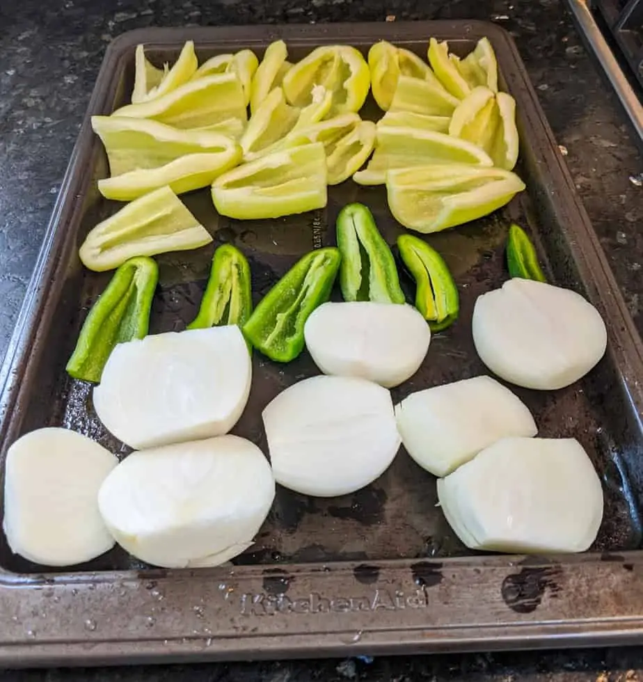 Cut onions & peppers in half and place cut side up on baking sheet