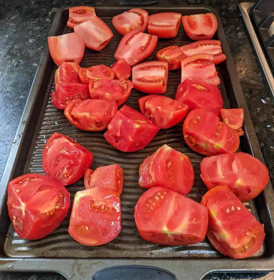 Cut tomatoes in half and place cut side up on baking sheet