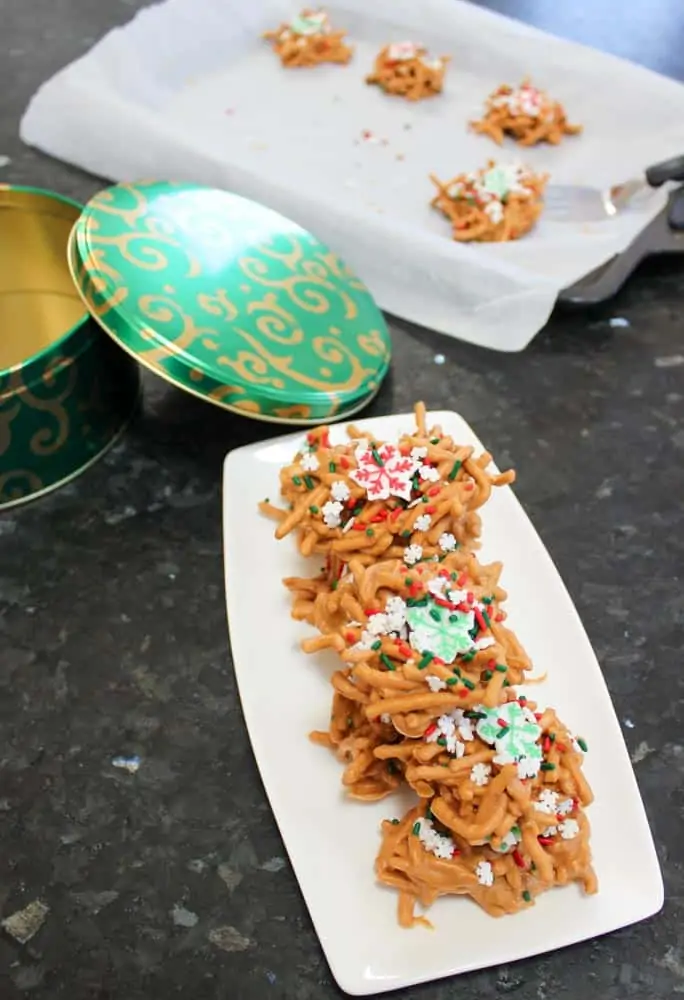 Removing No Bake Chow Mein Noodle Cookies from cookie sheet and putting in tin and on plate