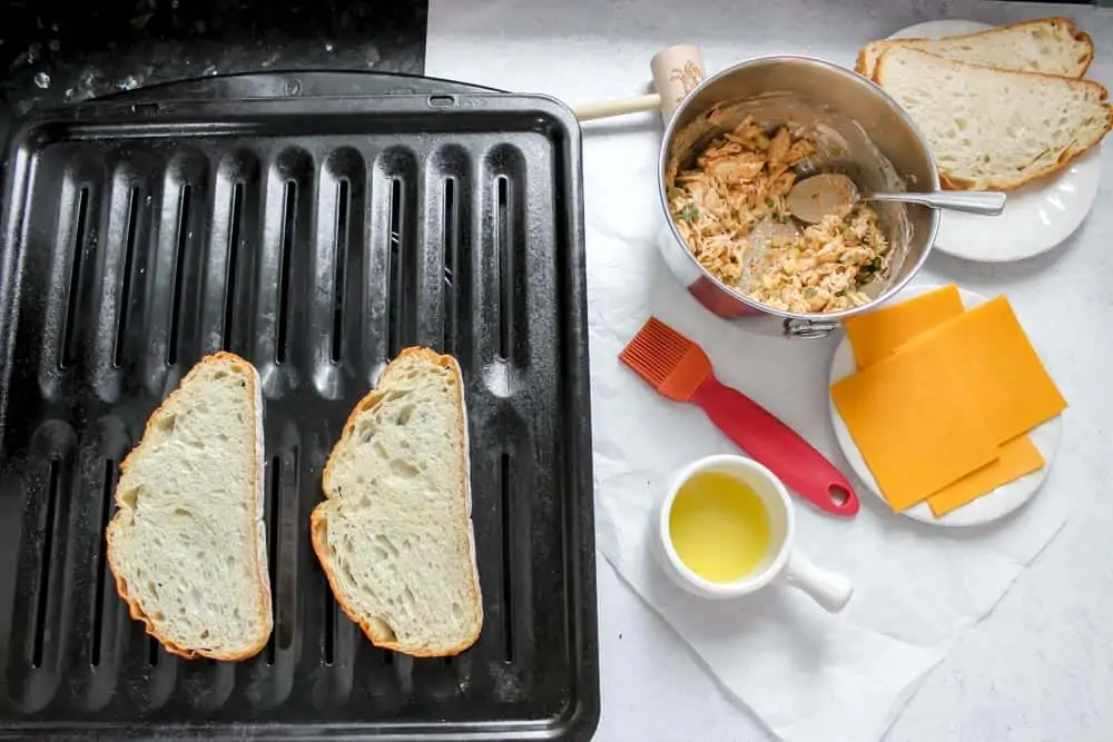 Butter outsides of bread slices