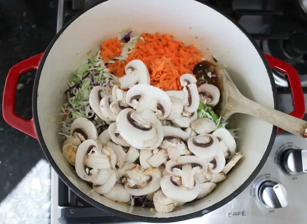 Add mushrooms, coleslaw mix and carrots
