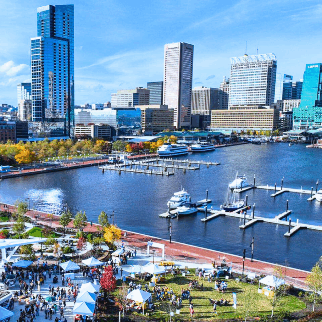 Visitors enjoying an outdoor festival on the Inner Harbor in Baltimore, MD