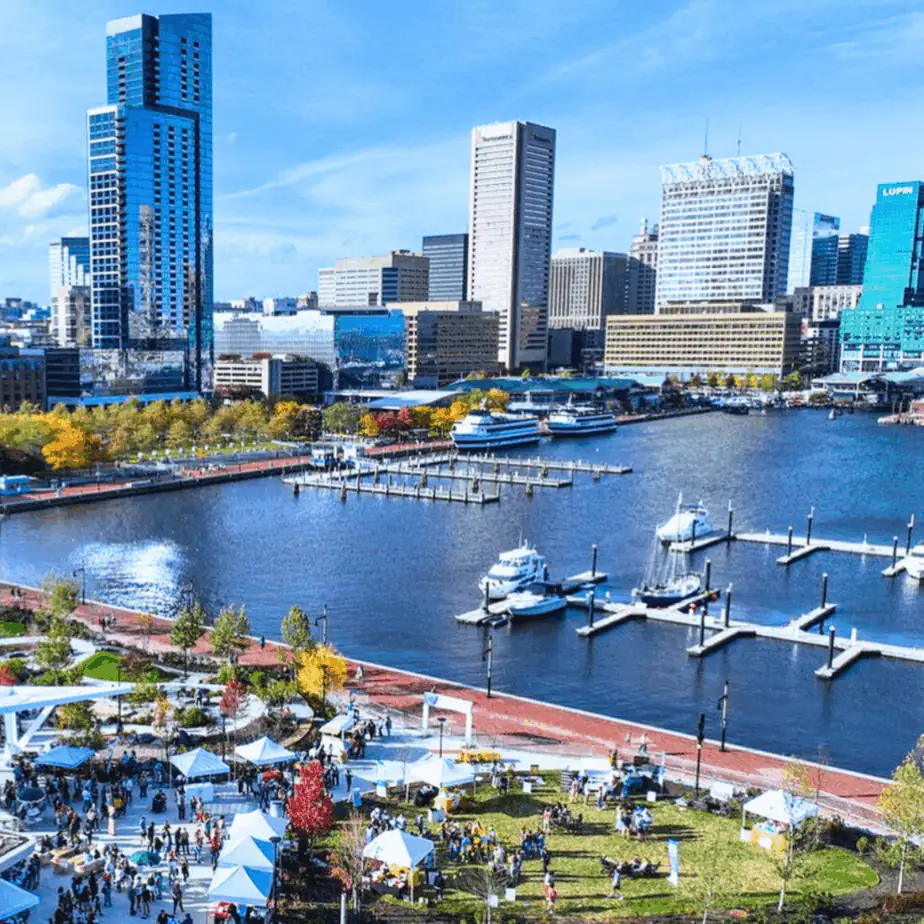 Visitors enjoying an outdoor festival on the Inner Harbor in Baltimore, MD