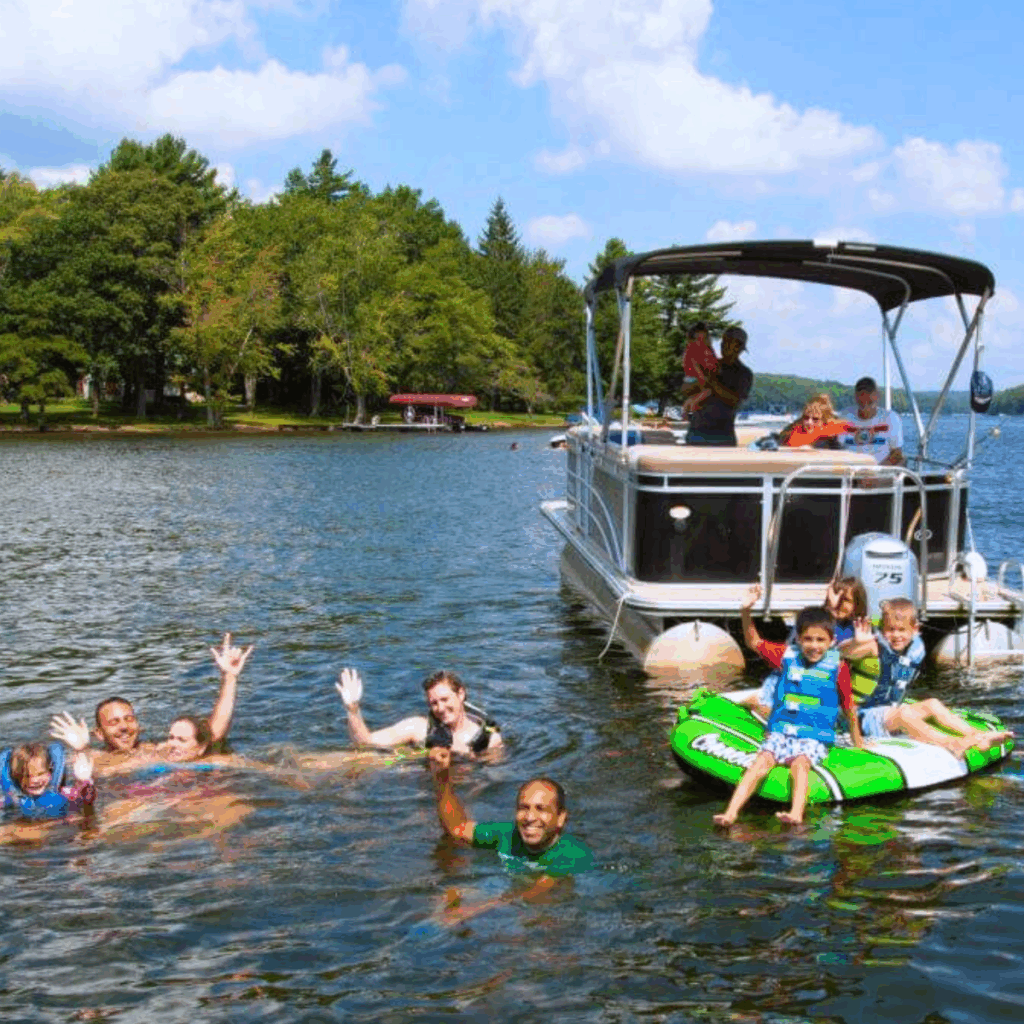 Family and friends enjoying Deep Creek lake on a pontoon boat and tube
