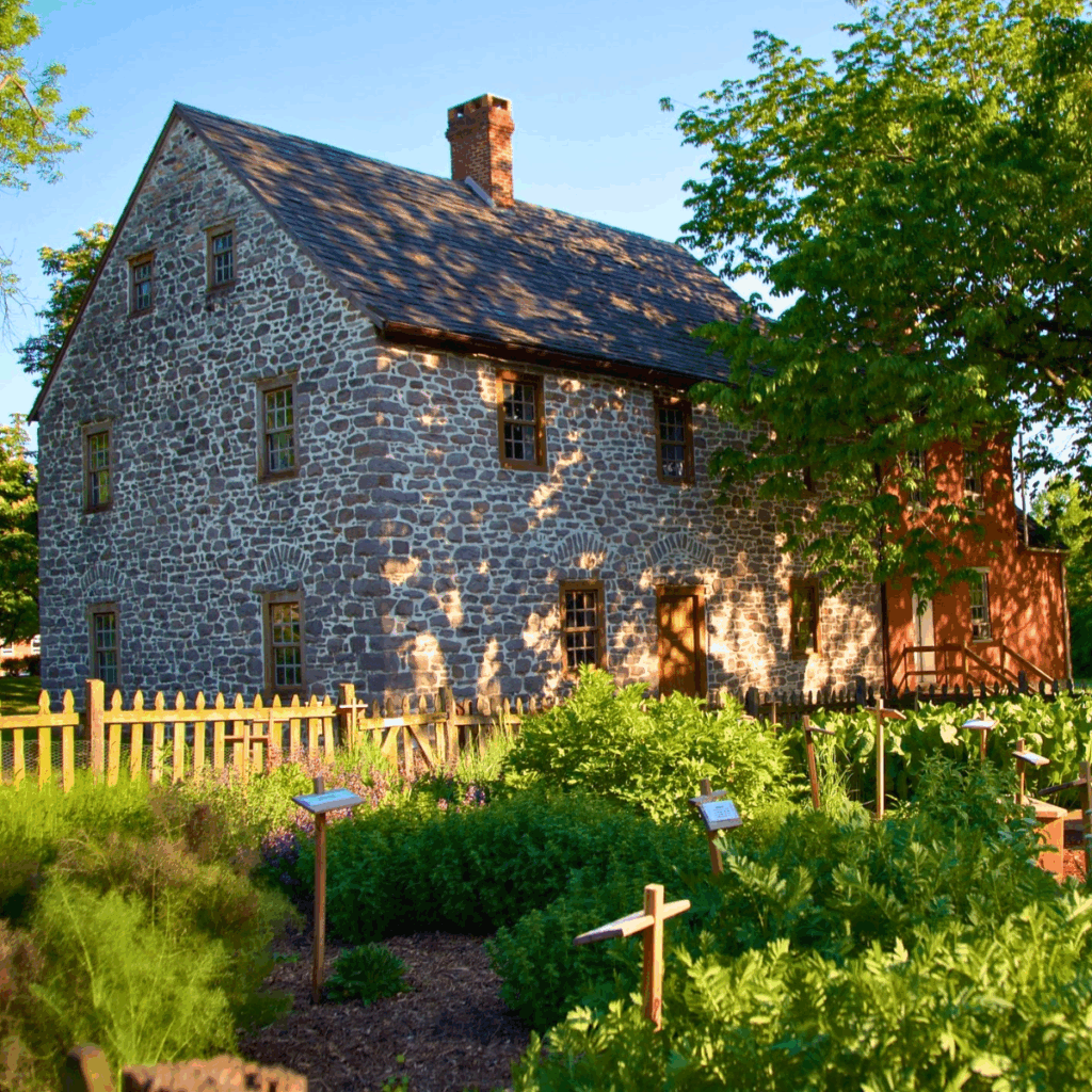 Aging parents walk through the quiet gardens of the historic Schifferstadt Heritage Garden in Frederick, MD