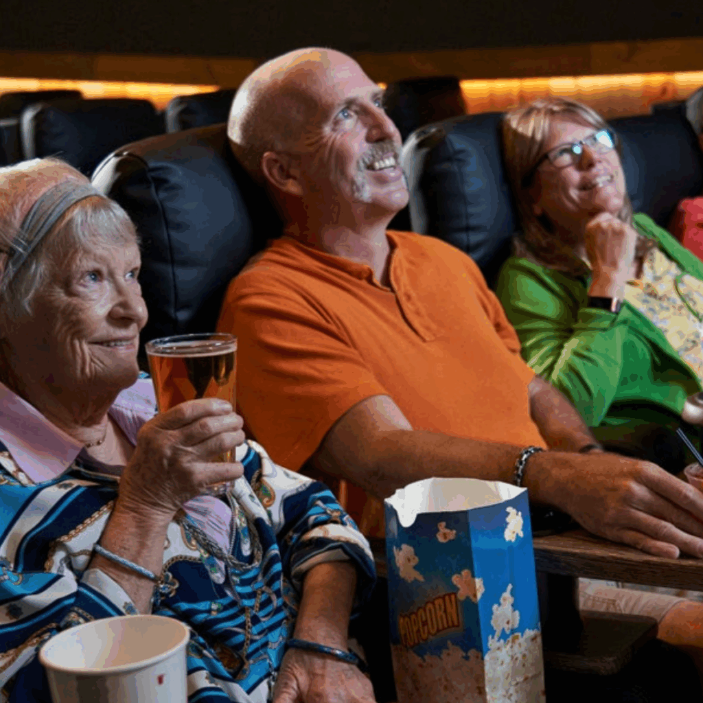Aging parent watching a senior-friendly matinee movie at Warehouse Cinemas in Frederick, MD