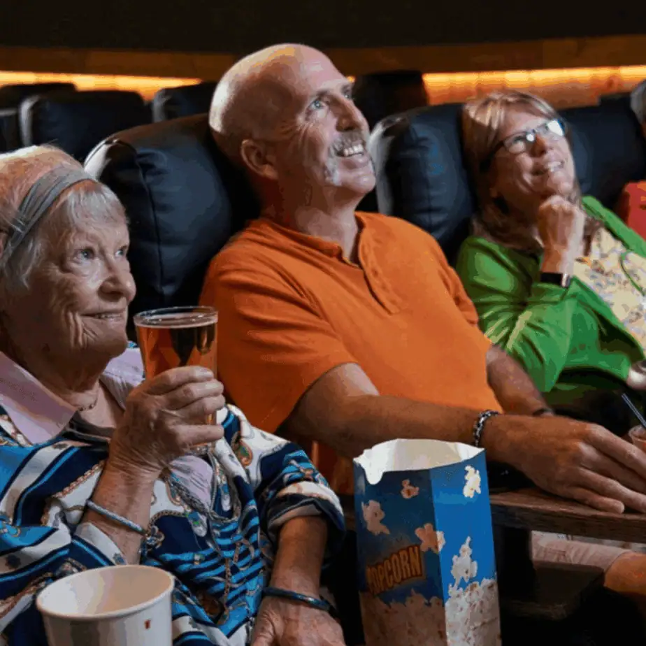Aging parent watching a senior-friendly matinee movie at Warehouse Cinemas in Frederick, MD
