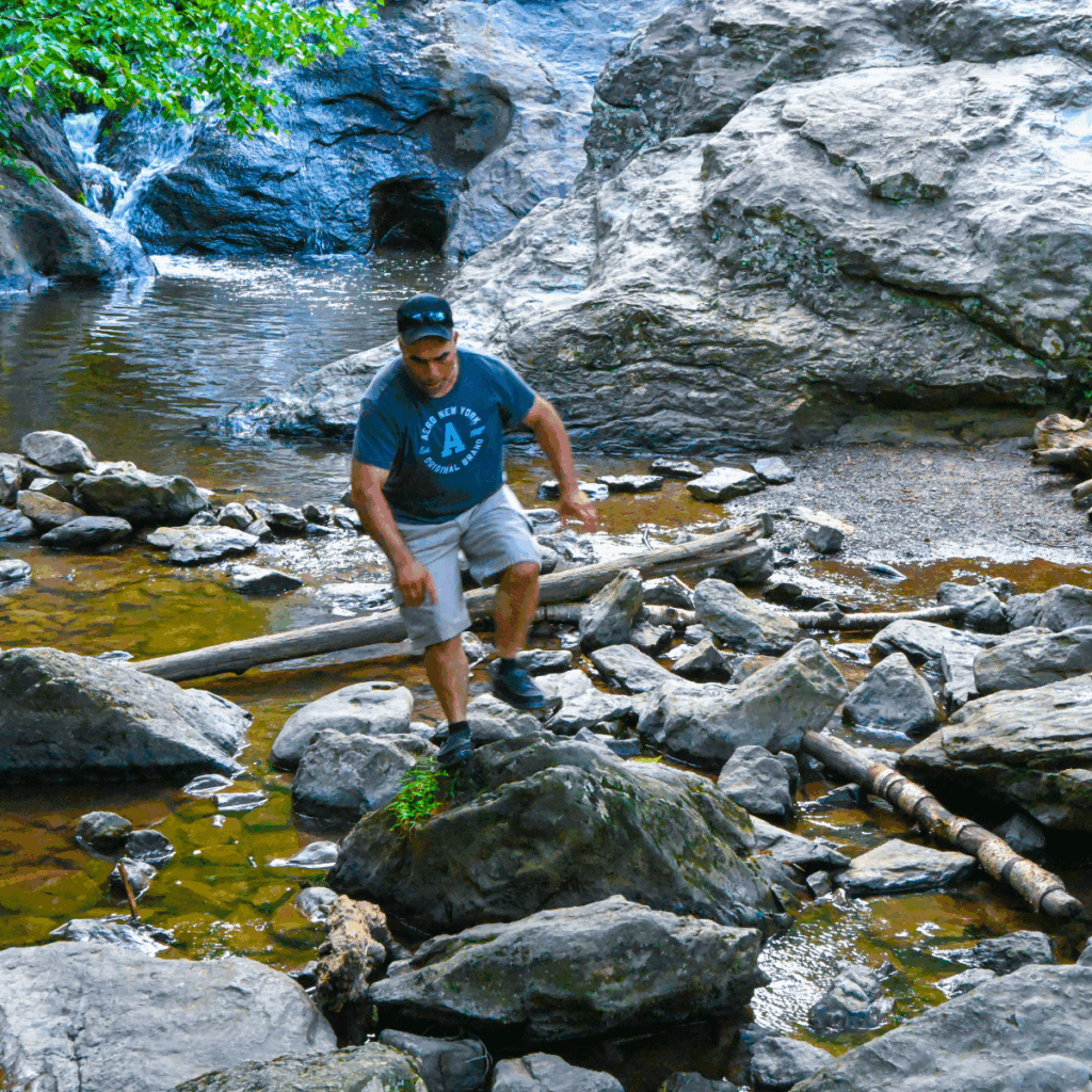 Cunningham Falls State Park  Man walking at base of waterfalls