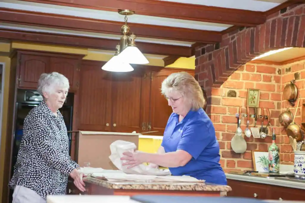 Stress Free Solutions Team Member carefully wrapping kitchen items for a client's move