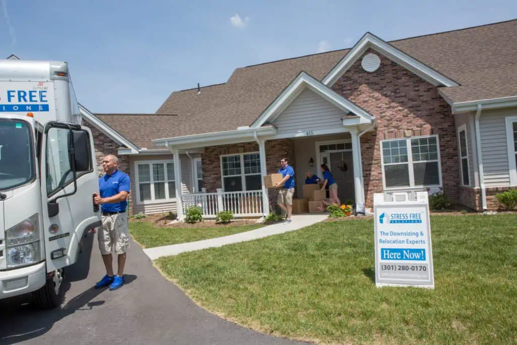 Stress Free Solutions team members moving boxes from client's home into moving truck