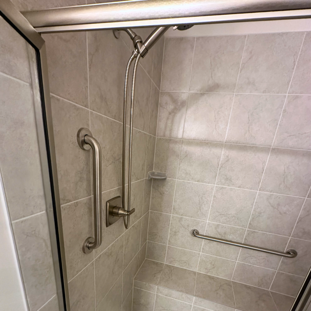 Accessible bathroom with grab bars and walk-in shower designed for safety and aging in place
