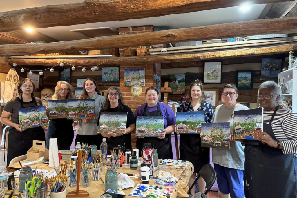 Participants painting colorful acrylic artwork during a beginner-friendly painting class at Frederick MADE in downtown Frederick, Maryland.